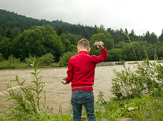 Image showing Boy Throw Stones In The River