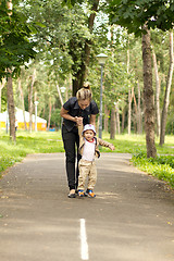 Image showing Baby Learning to Walk in Park