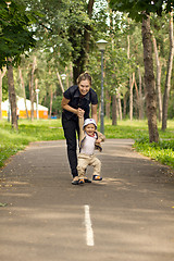 Image showing Baby Learning to Walk in Park