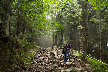 Image showing Mother and son in the mystic green foggy forest