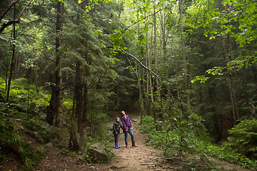 Image showing Mother and son in the mystic green foggy forest