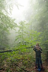 Image showing Mother and son in the mystic green foggy forest