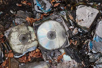 Image showing CD\'s thrown away in garbage dump piles