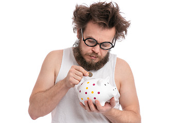 Image showing Crazy bearded man with piggy bank