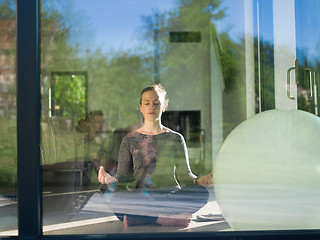 Image showing young woman doing morning yoga exercises