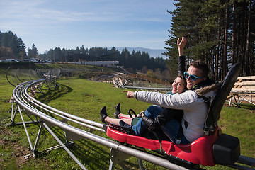 Image showing couple enjoys driving on alpine coaster