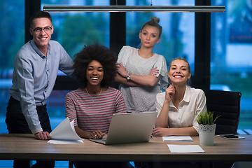 Image showing Multiethnic startup business team in night office