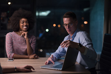 Image showing Multiethnic startup business team in night office