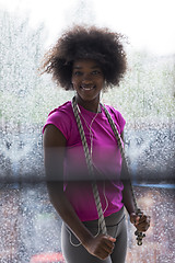 Image showing portrait of young afro american woman in gym while listening mus