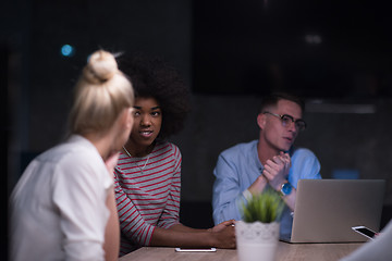 Image showing Multiethnic startup business team in night office