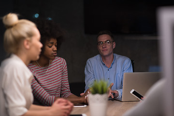 Image showing Multiethnic startup business team in night office