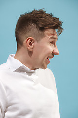 Image showing The happy business man standing and smiling against studio background.