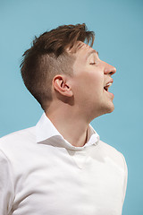 Image showing The happy business man standing and smiling against studio background.