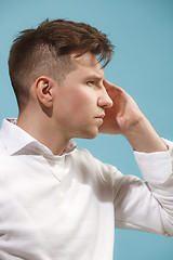 Image showing Young serious thoughtful businessman. Doubt concept.