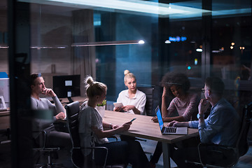 Image showing Multiethnic startup business team in night office