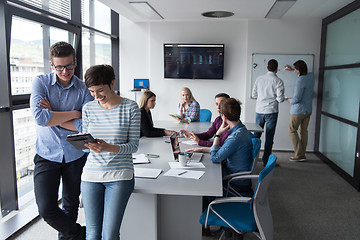 Image showing Two Business People Working With Tablet in office