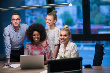 Image showing Multiethnic startup business team in night office