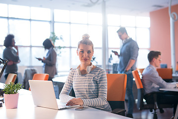 Image showing businesswoman using a laptop in startup office