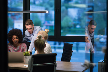 Image showing Multiethnic startup business team in night office