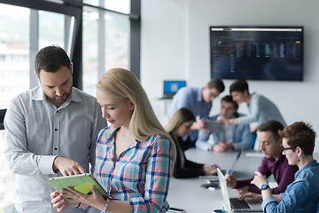 Image showing Two Business People Working With Tablet in office