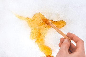 Image showing Sweet maple taffy on white snow