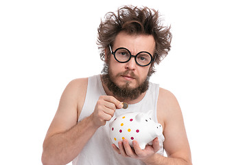 Image showing Crazy bearded man with piggy bank