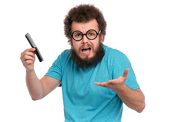 Image showing Crazy bearded man with hairbrush