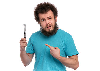 Image showing Crazy bearded man with hairbrush