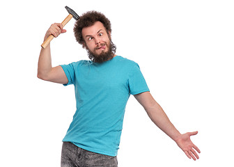 Image showing Crazy bearded man with hammer