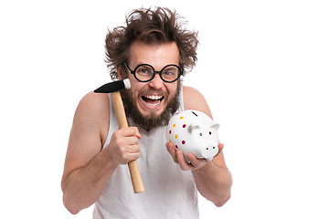 Image showing Crazy bearded man with piggy bank