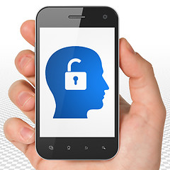 Image showing Finance concept: Hand Holding Smartphone with Head With Padlock on display