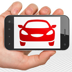 Image showing Travel concept: Hand Holding Smartphone with Car on display