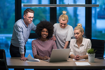 Image showing Multiethnic startup business team in night office