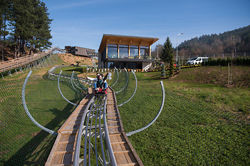 Image showing couple enjoys driving on alpine coaster