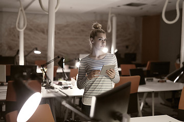 Image showing woman working on digital tablet in night office