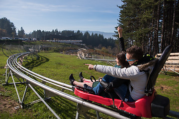 Image showing couple enjoys driving on alpine coaster