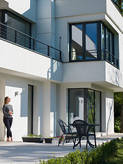 Image showing women using tablet computer in front of luxury home villa