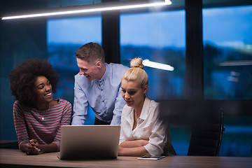 Image showing Multiethnic startup business team in night office