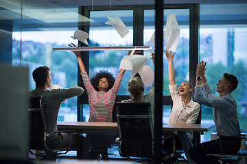 Image showing multiethnic Group of young business people throwing documents