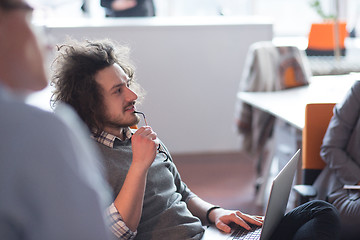 Image showing businessman working using a laptop in startup office