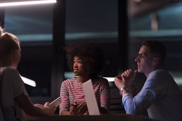 Image showing Multiethnic startup business team in night office