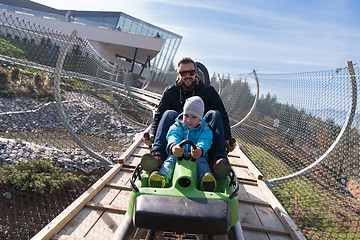 Image showing father and son enjoys driving on alpine coaster