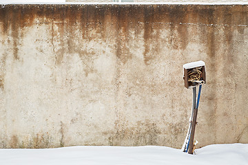 Image showing abandoned grunge house with electrical equipment near the wall in winter.