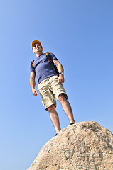 Image showing Hiker standing on a rock