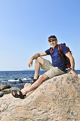 Image showing Hiker sitting on a rock