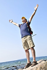 Image showing Hiker standing on a rock