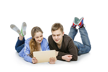 Image showing Teen boy and girl sitting with tablets