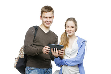 Image showing Teen boy and girl standing with mobile phones