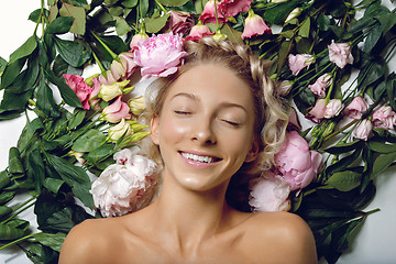 Image showing Beautiful girl lying in flowers