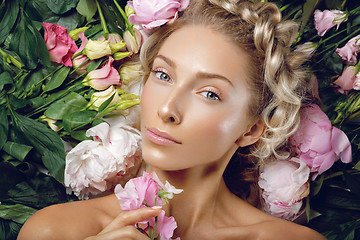 Image showing Beautiful girl lying in flowers